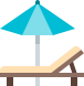 Open umbrella next to a lounger